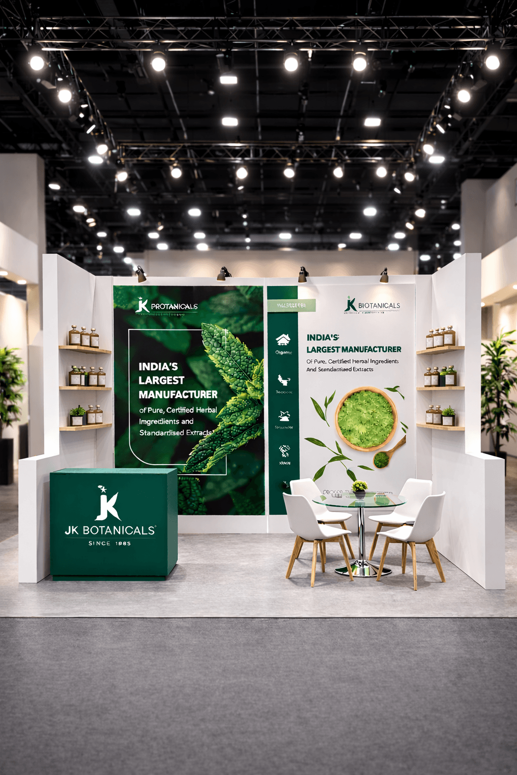 JK Botanicals exhibition stand with green herbal graphics, a branded counter, and white meeting chairs.